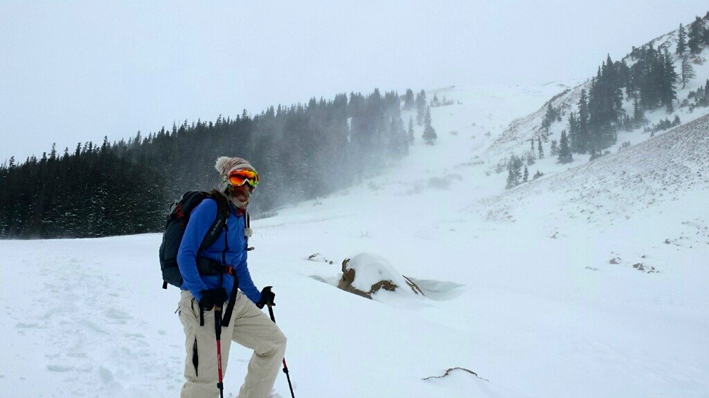 winter hiking and snowshoeing - storm blowing in