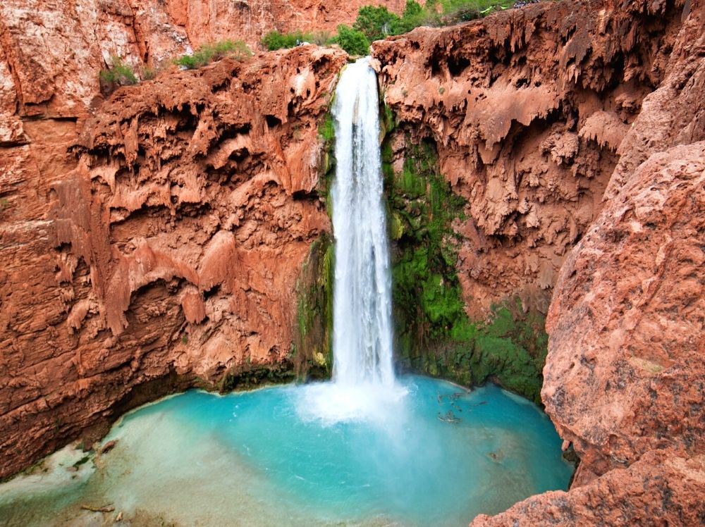 The beautiful blue water of Havasupai Waterfall is one of the main Grand Canyon attractions.