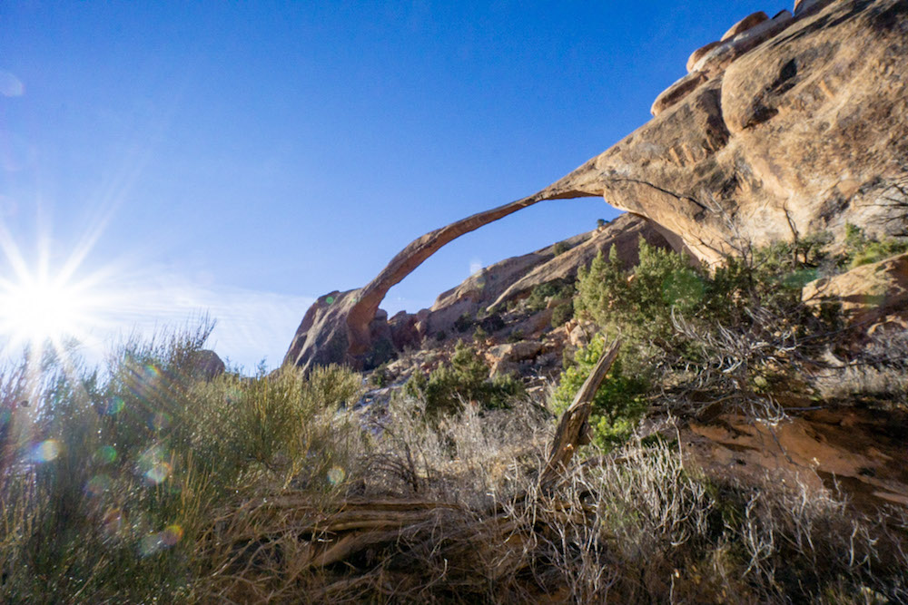 The sun shining down on Landscape Arch during our Arches National Park Itinerary.