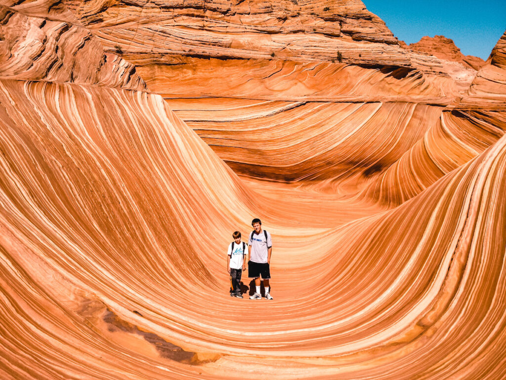 Two young boys standing in front of the wave in Arizona. 
