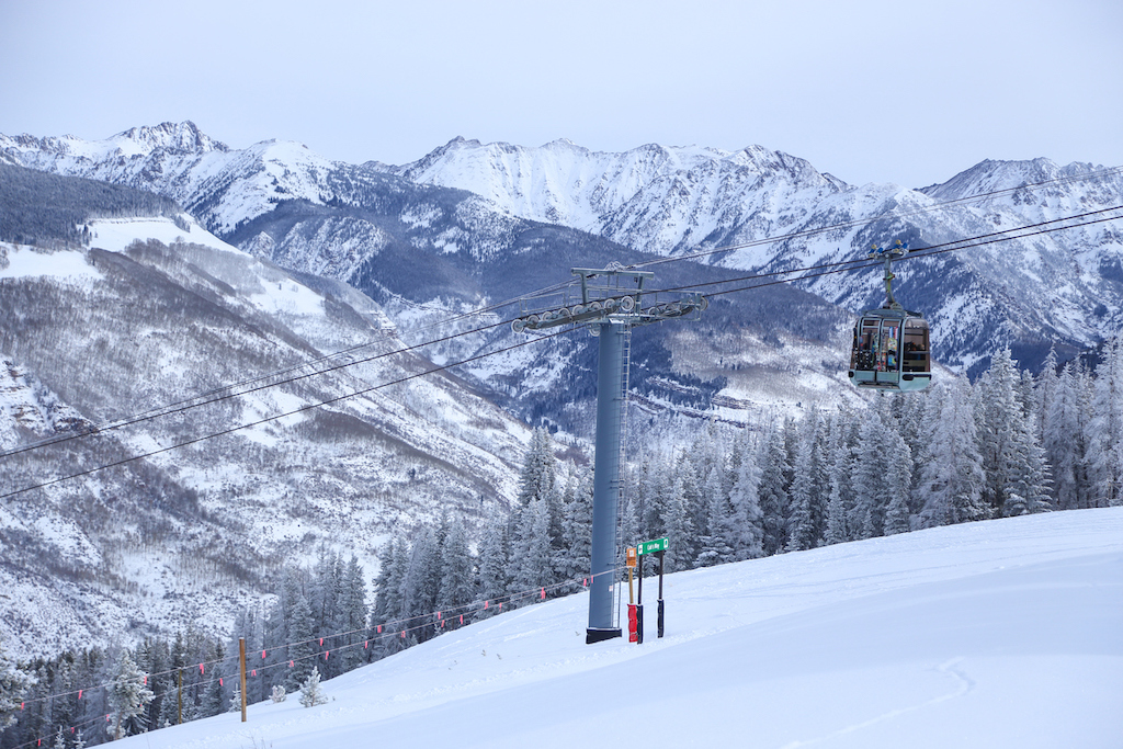 Vail Gondola and ski lift against the snow-covered ski slopes and mountains of Vail in winter.