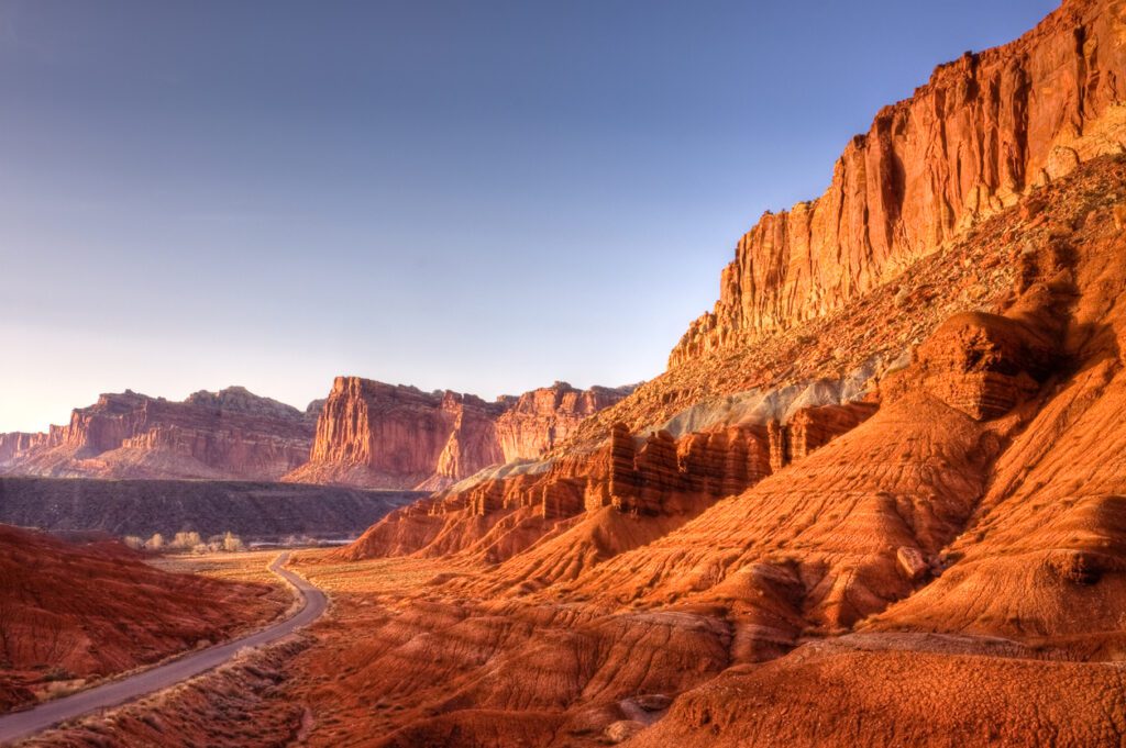 View of a road running through Capitol Reef with stunning red rock landscapes. 