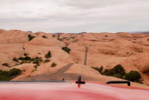 View of Arches National Park from a red jeep during the best jeep tours in Moab.