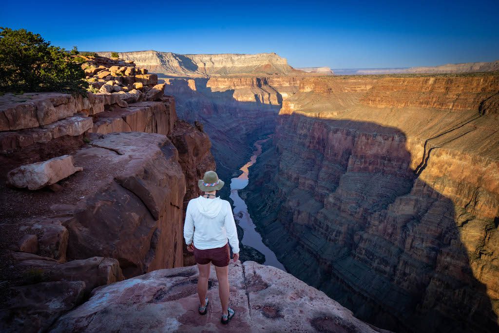 Person looking out at the Grand Canyon during sunset. 