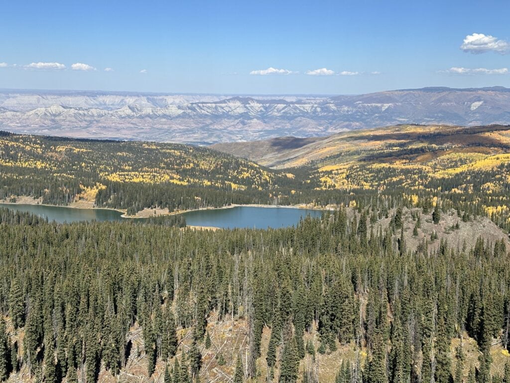 A view from the crags crest trail during the fall with large stands of aspens and pine forests dotted with lakes