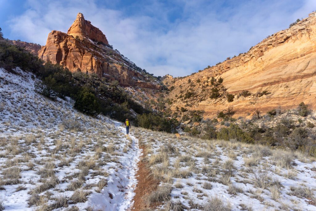 A hiker walking along the snow covered trails and through the mountains of Colorado. 