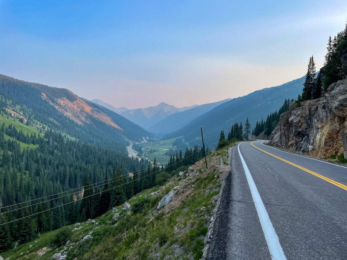 The paved road along the Million Dollar Highway which offers stunning views of the mountains and rivers that run through Durango at sunset.