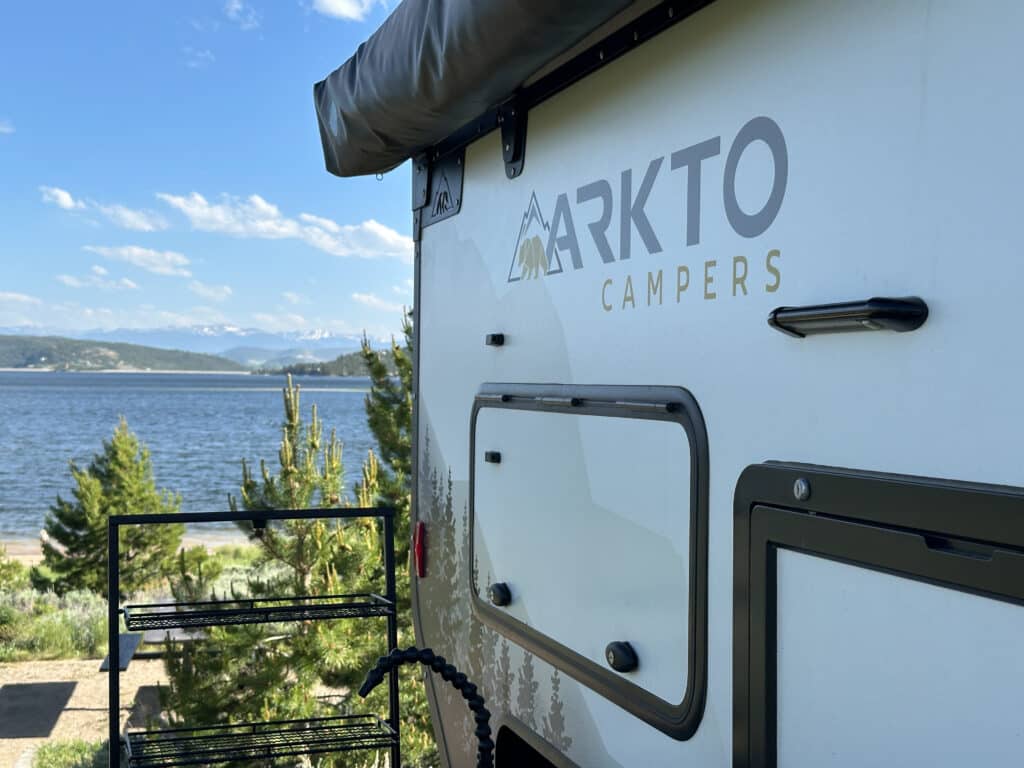 An arkto camper overlooking an alpine lake at the stillwater campground in granby colorado