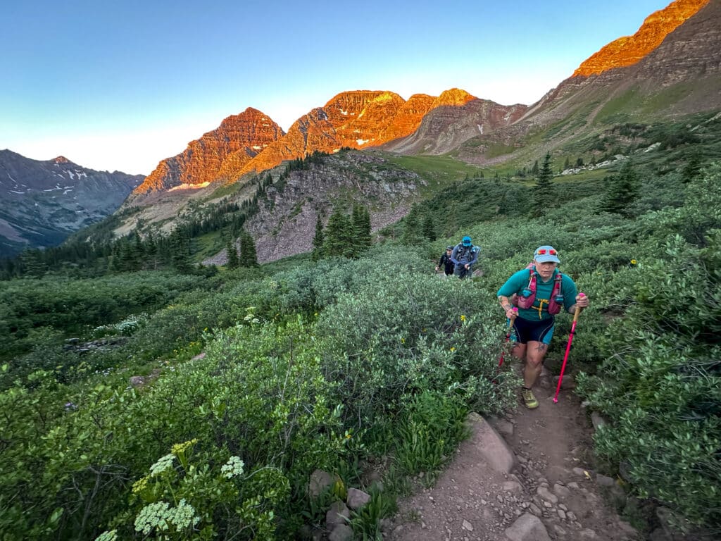 Three trail runners making their way up the Four Passes Loop Trail outside of aspen