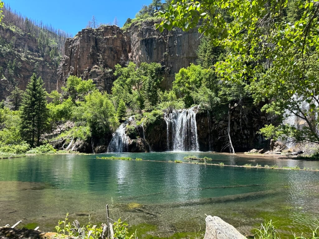 A waterfall coming out of a lush cliff at hanging lake colorado