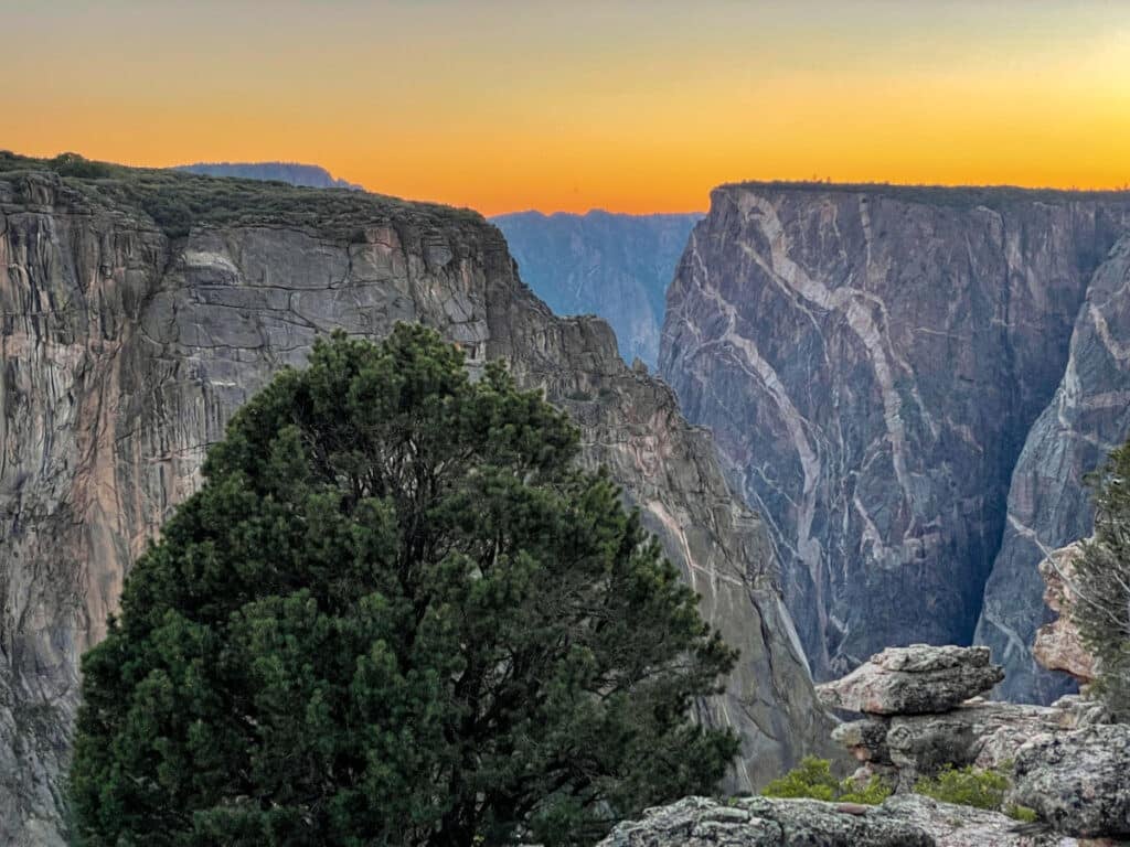 An enormous granite canyon wall at sunset in the Black Canyon of the Gunnison.