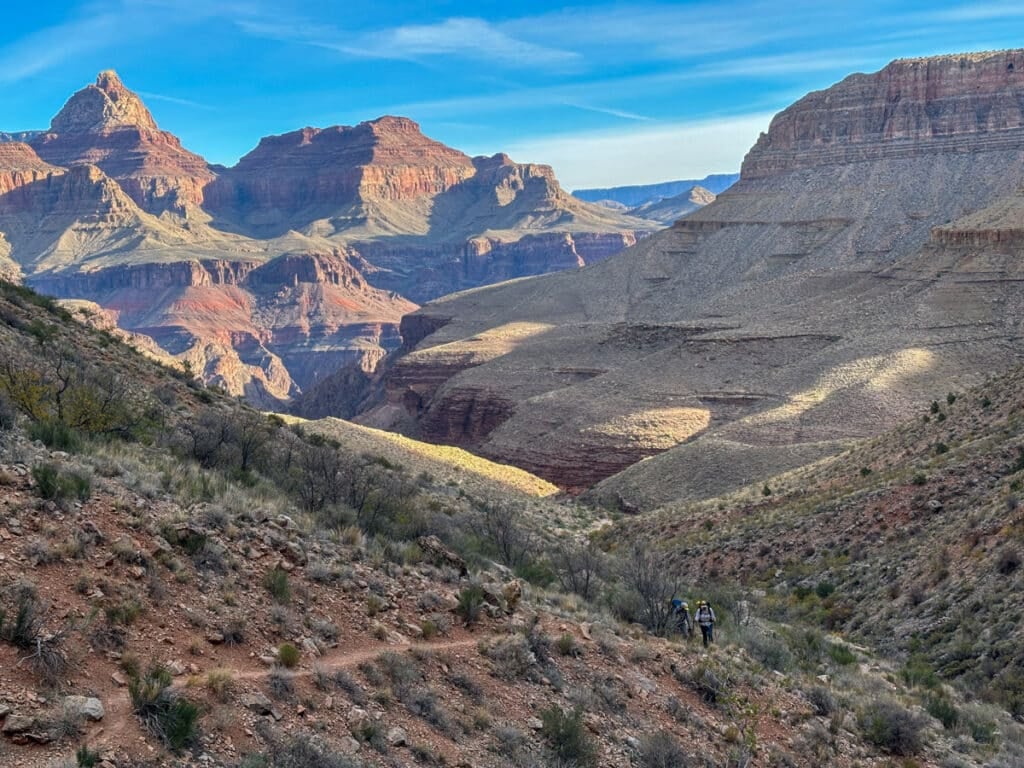 People hiking up the Grandview Trail in the Grand Canyon in the early morning light.